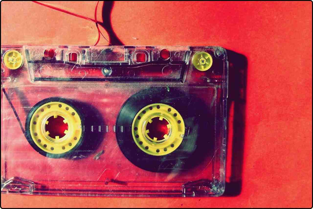 Classic audio cassette with a vintage look on a red background.